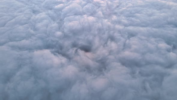 Aerial View From High Altitude of Earth Covered with Puffy Rainy Clouds Forming Before Rainstorm