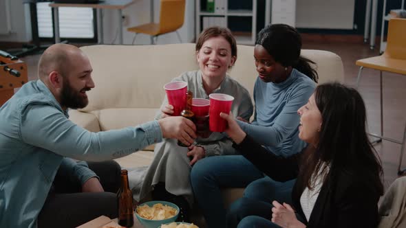 Coworkers Clinking Cups and Bottles to Enjoy Leisure After Work