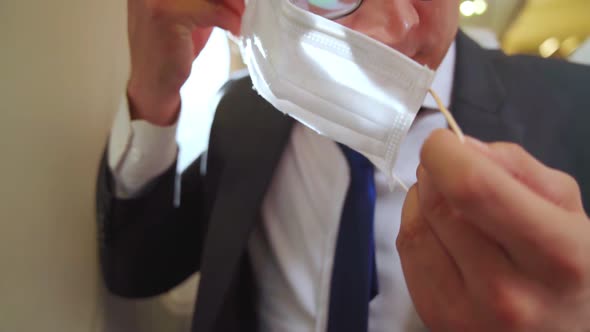 Traveler Wearing Face Mask While Traveling on Commercial Airplane