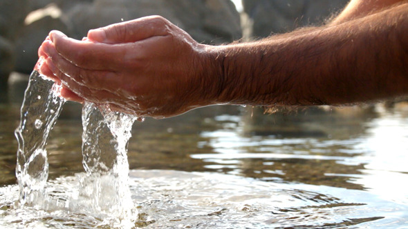Collecting Water with Hands at the Seashore