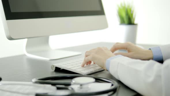 Doctor Fill Out Patient Information On Computer