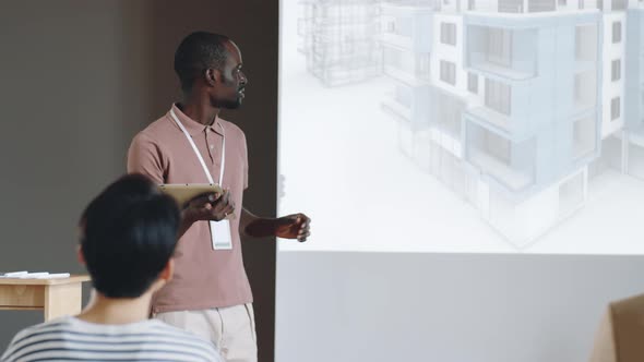 Black Architect Presenting Project on Business Conference