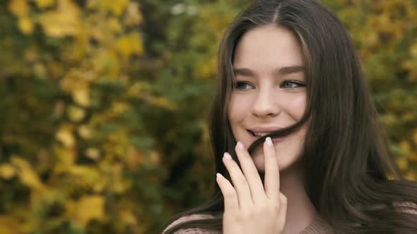 Portrait of Absolutely Happy Girl with Long Hair and Cute Smile in Park