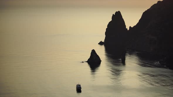 Speedboat Sailing Fast in a Calm Sea on Background of Sea Landscape with Rocky Coastline