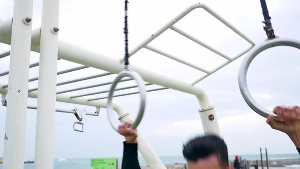 Man training at the beach outdoor gym