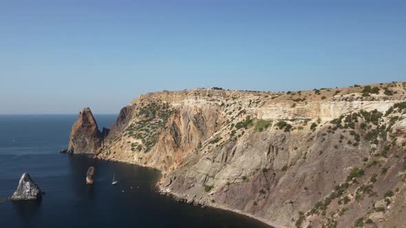 Aerial View From Above on Calm Azure Sea and Volcanic Rocky Shores