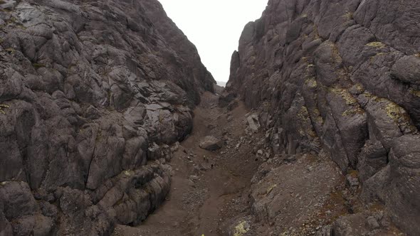 A Lonely Hiker Walks Through a Mountain Gorge