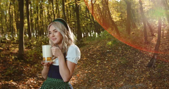 Slavic Girl in National Costume Holds a Mug of Beer in Beautiful Autumn Forest