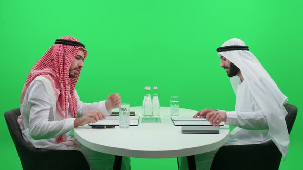 Business Meeting of Two Arab Businessmen Man in a White Kandura Sign Financial Documents with a