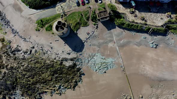 Top-down aerial view over Irish tower and beach