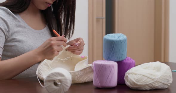 Woman knits crochet at home