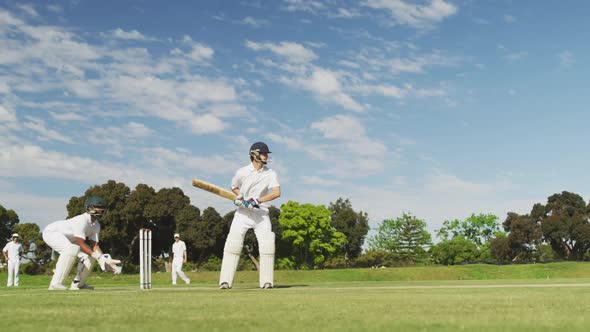 Cricket player shooting in the ball in a pitch
