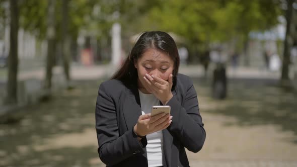 Shocked Girl Using Mobile Phone on Street