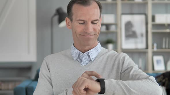 Middle Aged Man Browsing Internet on Smartwatch