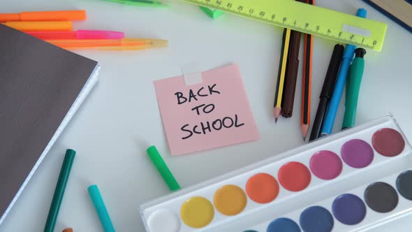 Pupil Girl Taking School Supplies From Table