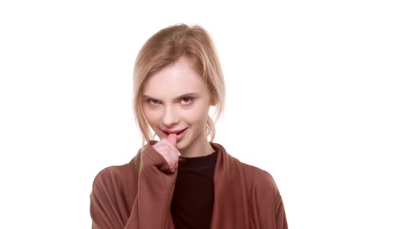 Cute Young Caucasian Teenager Girl Standing on White Background and Flirting in Slowmotion