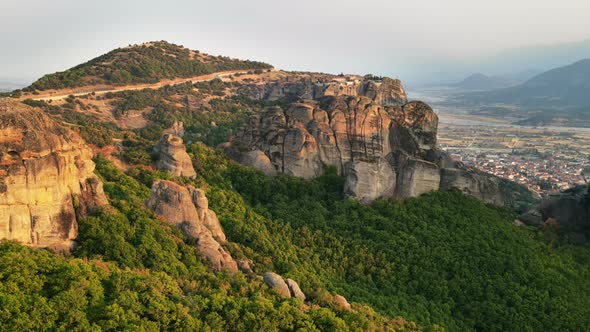 Aerial drone view of the Meteora in Greece at sunset. Rock formations with Orthodox monasteries