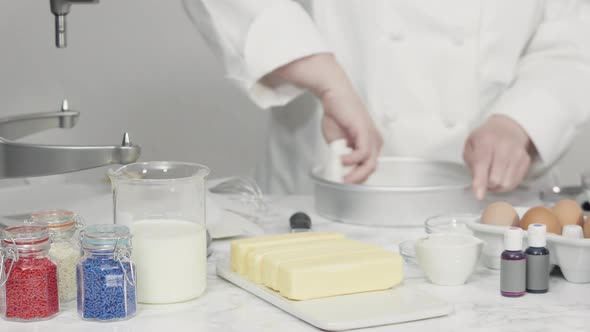 Time lapse. Step by step. Greasing cake pans with butter to bake a three-layer vanilla cake.