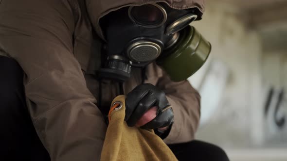 Close Up Survivor Stalker Digging in His Old Backpack in Midst of Uninhabited Abandoned Old Houses