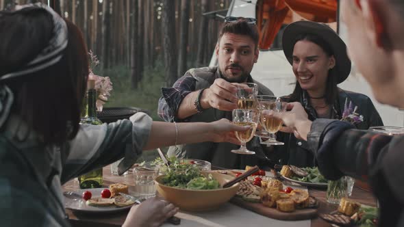 Friends Toasting During Dinner at Campground