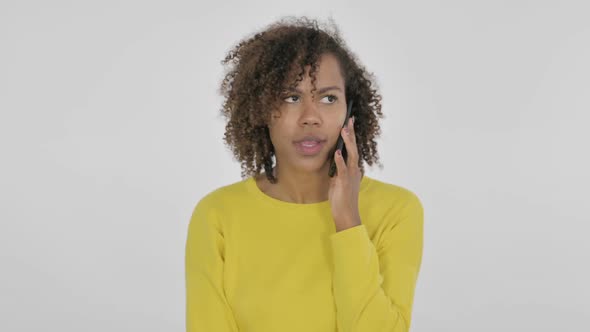Aggressive Young African Woman Angry on Smartphone on White Background