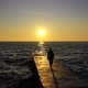 Slow motion female walking by the ocean with waves on sunset - VideoHive Item for Sale