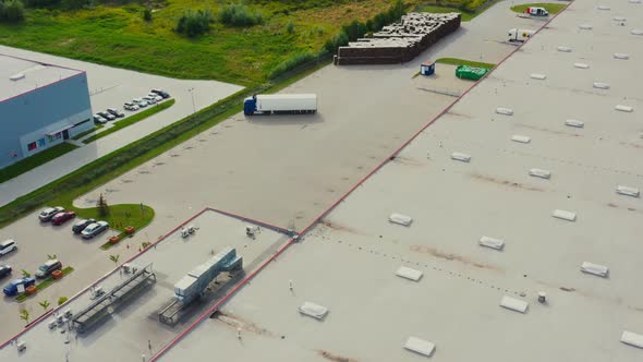 Aerial view of the logistics warehouse with trucks waiting for loading