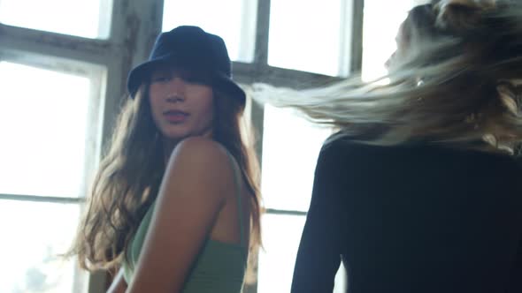 Two Girls are Dancing By the Window in Small Studio