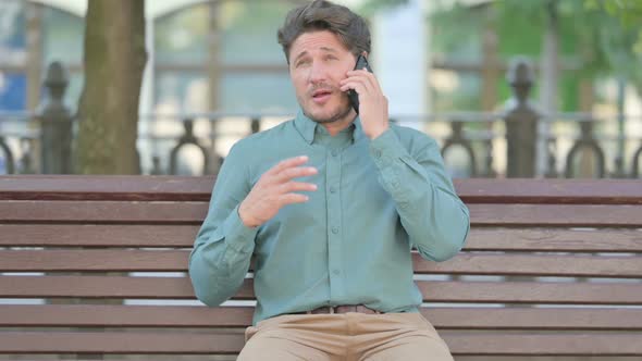 Middle Aged Man Talking on Phone, Outdoor