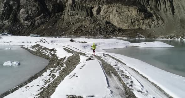 Woman trail runner cross country running in winter nature,Aerial view drone footage 