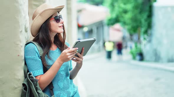 Woman Traveler Looking on Map Using Tablet PC or Digital Electronic GPS Navigation