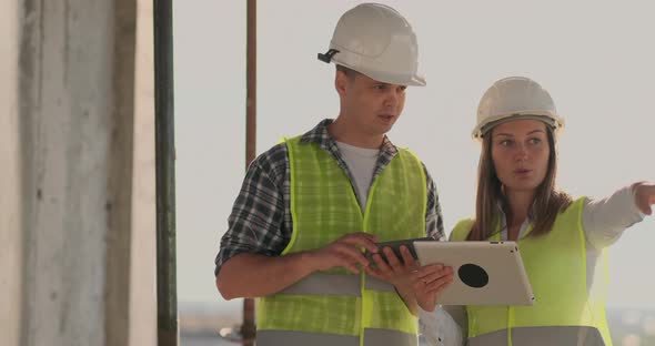 Engineers Designers Stand on the Roof of the Building Under Construction and Discuss the Plan and