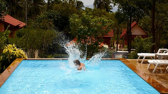 Jumping in Swimming Pool. Slow Motion