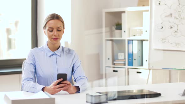 Businesswoman with Smartphone Working at Office 21
