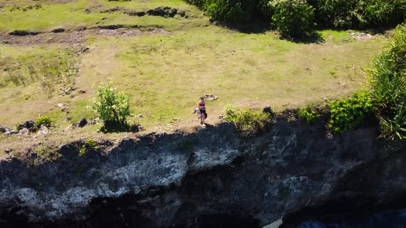 Fly Around Cliff Where Woman Stay Over Ocean