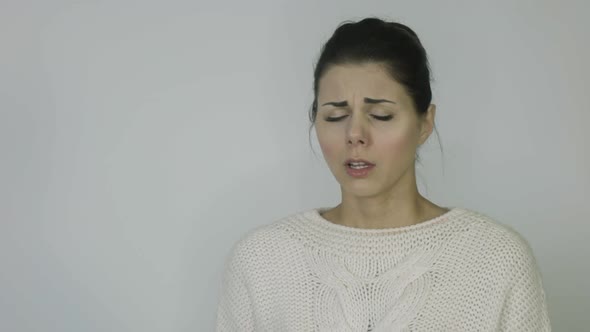 Girl with a High Temperature Sneezes on a White Background