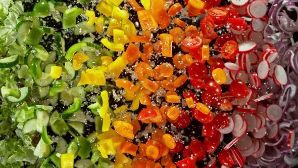 Super Slow Motion Shot of Flying Cuts of Colorful Fresh Vegetables and Water Drops at 1000Fps.