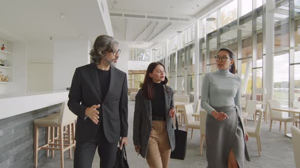 Multi-Ethnic Business People Walking Along Restaurant