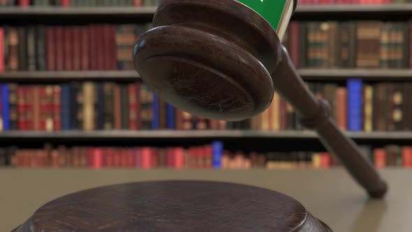 Flag of Saudi Arabia on Falling Judges Gavel in Court