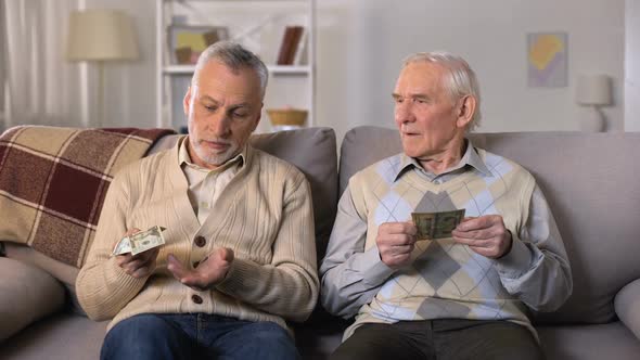Depressed Elderly Men Counting Money, Low Social Payment, Poverty Problems
