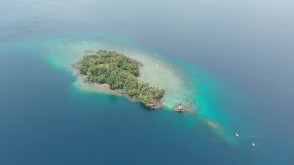 Aerial: flying over Banda Islands active volcano Gunung Api lava flows Indonesia