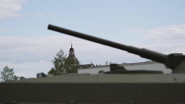 Dome of Church in Distance Between the Hull and Muzzle of the Tank