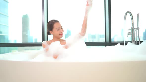 Young asian woman relax in bathtub