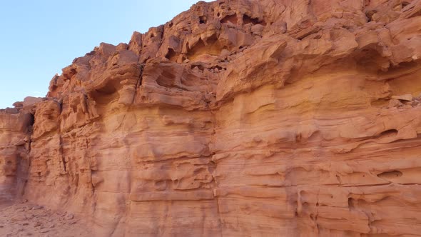 Orange rocky dunes in Egypt Canyon site with a panning camera move from right to left showing the ar