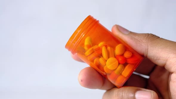 Close Up of Person Hand Holding Pill Container 