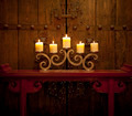 Candles burning on table in front of old rustic door - PhotoDune Item for Sale