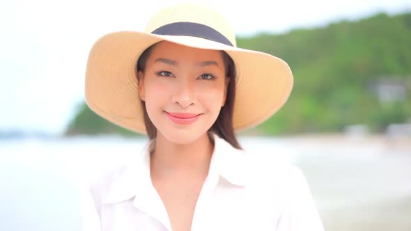Asian woman enjoy around beautiful beach sea ocean
