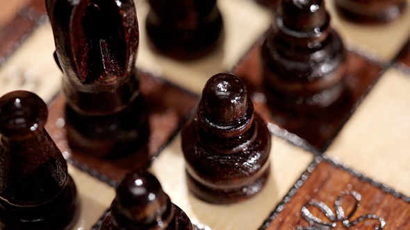 Black Chess Pieces On A Board