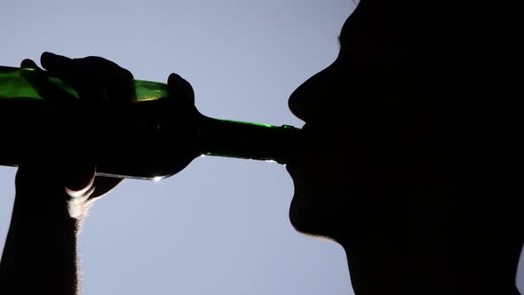 Hopeless Young Man Drinking Alcohol. Close Up