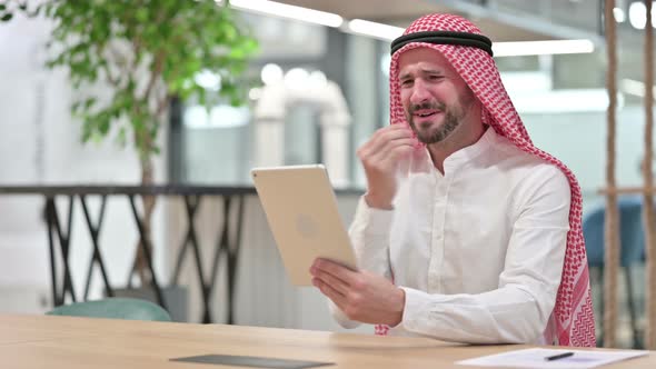 Successful Arab Businessman Celebrating on Tablet